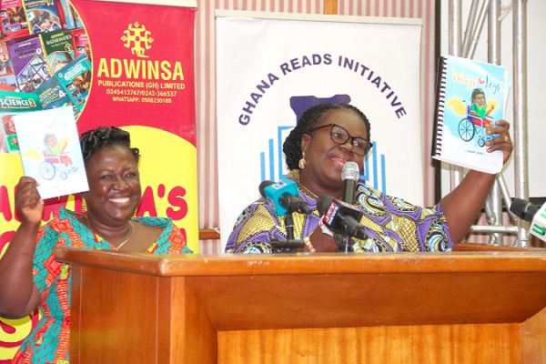 Gifty Sekyi-Bremansu (right), Head, Guidance and Counselling Unit, Ghana Education Service, being assisted by Mary Amoah Kuffuor (left), Founder, Clicks Africa Foundation and President of Inclusion Ghana, to launch the Wings for Legs Book in Accra. Picture: ELVIS NII NOI DOWUONA