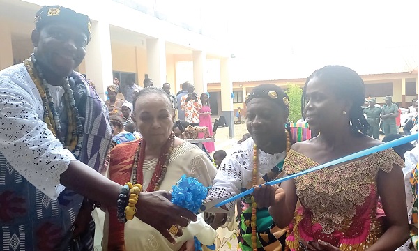 Togbi Akumey Geli-Adjorlolo III (left), Dufia of Atorkor, and Yvonne Akpene Ame-Bruce  (right), Anloga District Director of Education, cutting a tape to inaugurate the centre