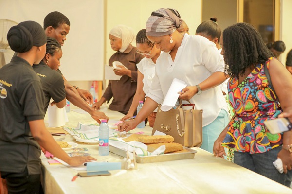  Some of the participants and judges having a taste of the bread produced by the students