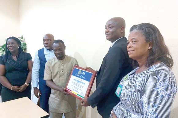 Joseph Appiah (2nd from right), the Financial Controller of GREL, receiving the award from Joseph Boateng (3rd from right), the Takoradi Area Director of GRA