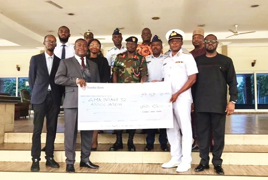 Mawuko Afadzinu (left, front row), Head of Brand and Marketing, Stanbic Bank, handing over the cheque for GH¢95,000 to Air Commodore Eric Agyen-Frempong, a representative of the 1991 Group of the Ghana Military Academy RCC. With them are serving and retired military officers