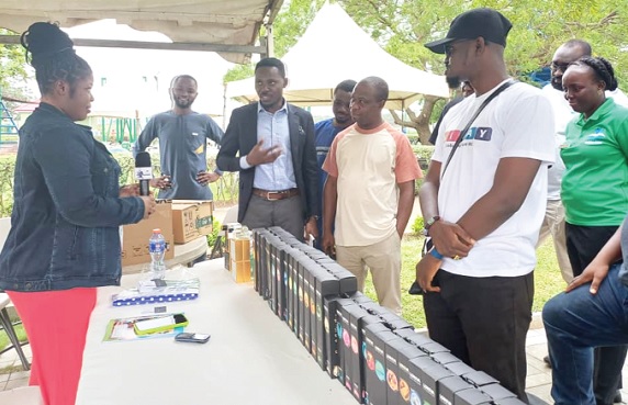 Abena Ayensua (left), an exhibitor, explaining some of the benefits of her products to Isaac Ntiamoah (3rd from left), Marketing Manager, Lakeside Estate, and other dignitaries at the exhibition