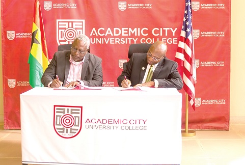 Prof. Fred McBagonluri (left), the President of Academic City University, and Daniel A. Wubah, the President of Millersville University, signing the MoU