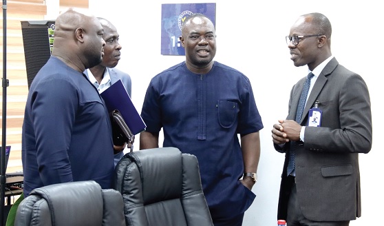 Dr Albert Antwi-Boasiako (right), Director-General, Cyber Security Authority, interacting with Frank Mante (2nd from right), Chief Executive Officer, Public Procurement Authority, and some officials after the press conference in Accra. Picture: ELVIS NII NOI DOWUONA