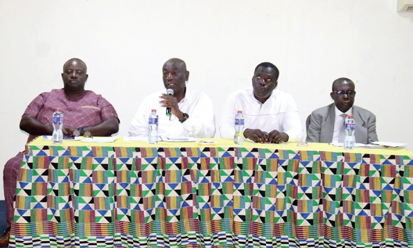 Joshua Ansah, acting Deputy Secretary-General of TUC, speaking at the event. With him are Ofosu Asamoah (left), Executive Secretary of the NLC, Ignatius Baffour Awuah (2nd from right), Minister of  Employment and Labour Relations, and Justice Kwabena Asuman-Adu, Chairman of NIC