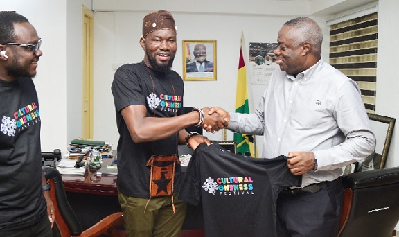 Tengol K. Kplemani (2nd from left), CEO, The Taste of Afrika, presenting a T-shirt for the festival to Dr Awal Mohammed, Minister of Tourism, Arts and Culture, while Fred Agyemang - Branding and Communications Director of Taste of Africa, looks on