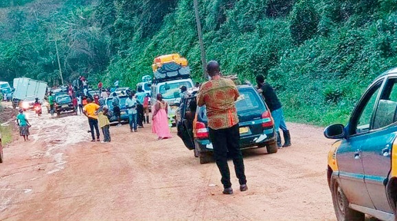 Stuck vehicles on the muddy portions of the main Samanye Barrier-Jaway Wharf road leaving passengers stranded. Picture: Dotsey Koblah Aklorbortu
