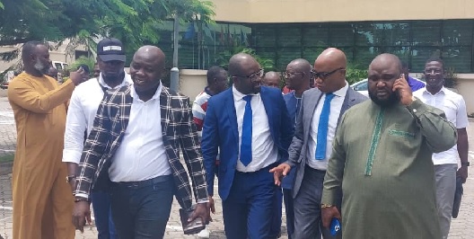 Mr. Kurt Okraku (3rd from left) and Mr Mark Addo in a conversation after taking their turns at the vetting on Monday