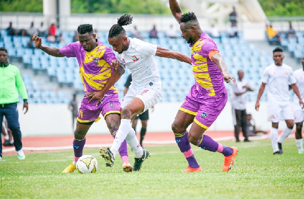 Isaac James of Remo Stars is sandwiched between Medeama SC skipper, Vincent Atinga (right) and Godknows Dzakpasu
