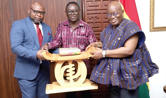 President Akufo-Addo presenting a gift to Mauricio Mauro Epkua Obama (left), outgoing Equatorial Guinean Ambassador to Ghana, at the Jubilee House when the latter bid farewell to the President. With them is Emmanuel Enos (middle), Director, State Protocol.  Picture: SAMUEL TEI ADANO