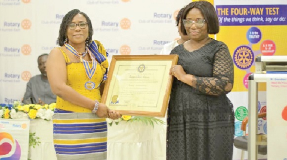 Matilda Adomolga-Adageba (left) receiving her certificate from Nana Esi Adade, Assistant Governor