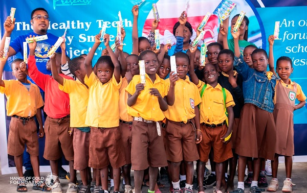 Some of the schoolchildren displaying their gifts after the event. With them are some officials of the Hands of Gold Foundation