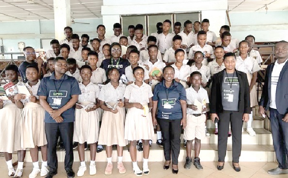 The team from Pan-African Savings and Loans Company Limited with some students after the donation