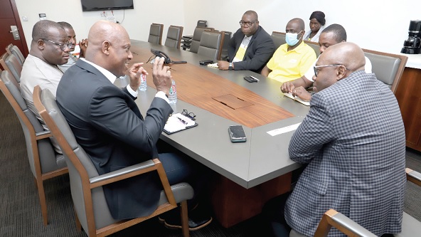 Ato Afful (left), Managing Director, GCGL, holding discussions with Philip Owiredu (right), Managing Director, CalBank, at the Head Office of the bank in Accra. With them are Theophilus Yartey (2nd from left), Editor, Graphic; Franklin Sowa (3rd from left), Director, Marketing, and some officials of the bank. Picture: SAMUEL TEI ADANO