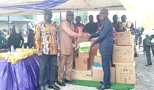 Dr Dominic Maison (2nd from left), Clinical Pharmacist, presenting medical consumables to Dr Michael Gyasi Danso, Medical Director of  Saltpond Municipal Hospital