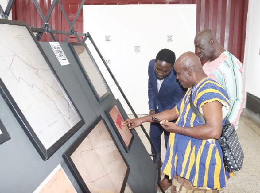 Bright Botwe (left), Grant Holder for British Library Endangered Archives Project, explaining a point to some patrons of the National Museum. Picture: ELVIS NII NOI DOWUONA