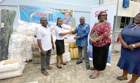 Eva Ameyaw, Human Resource Manager of CCT, presenting the items to Moses Anim, Deputy Minister of Fisheries and Aquaculture Development 