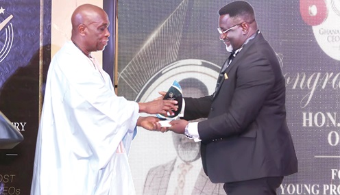Austin Gamey (left), CEO of PULSE Institute, presenting the award to Dr Andy Osei Okrah 