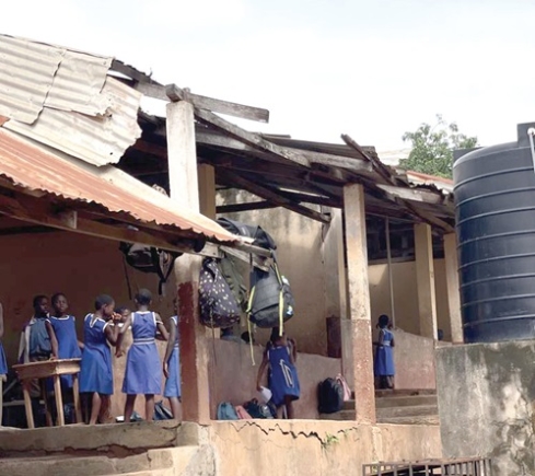 A portion of the dilapidated building with schoolchildren studying in it