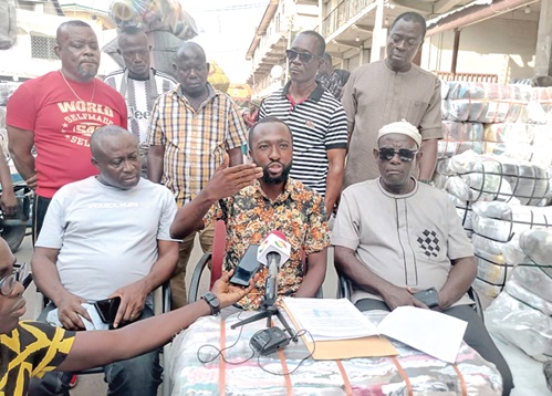 Edward Atobrah Binkley (seated middle), General Secretary of the Ghana Used Clothing Dealers Association, speaking at the press conference. With him are other members of the association