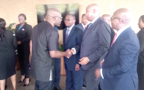Kojo Oppong Nkrumah (left), Minister of Information, exchanging pleasantries with Justice Omoro Tanko Amadu, Director, Judicial Training Institute. With them are some of the participants