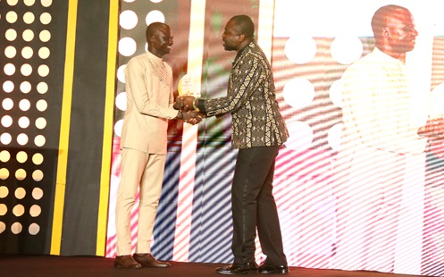 Timothy Ngnenbe (left) receiving the Best Mining Reporter Online/Print award from Kafui Dey during the Ghana Chamber of Mines Awards ceremony in Accra. Picture: ELVIS NII NOI DOWUONA