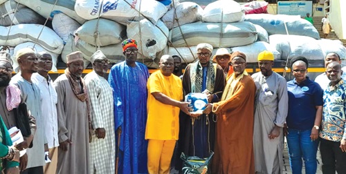 Alhaji Yussif Amudani Sulemana (middle), Eastern Regional Chief Imam, being assisted by Alhaji Mohammed Mahib Ciiba, the Nsawam-Adoagyiri Municipal Chief Imam, to present the items to Kwame Agyekum, the District Chief Executive for Asuogyaman. Looking on are other chiefs and Imams, as well as officials of the assembly