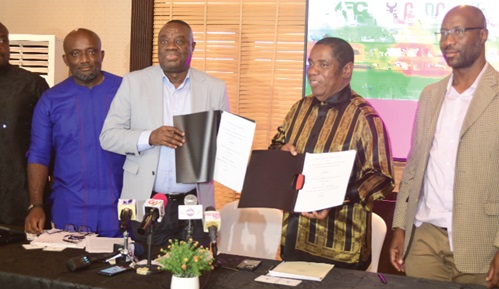 Dr Ibrahim Awal (2nd from left), Minister of Tourism, Arts &amp; Culture, and Robert Gumede, Chairman of GUMA Group, displaying the documents  after the signing ceremony in Accra. With them is Kwadwo Odame Antwi, Chief Executive Officer of Ghana Tourism Development Company Ltd