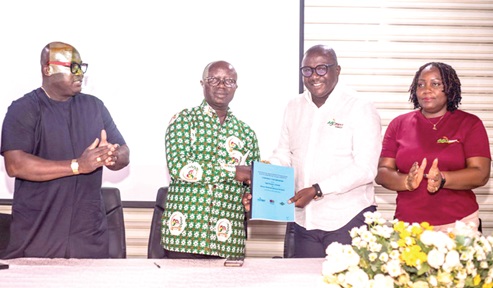 Osei Assibey Antwi (2nd from  left), Executive Director, NSS, and Daniel Fahene Acquaye (2nd from  right), CEO of Agri-Impact Consult, exchanging the signed document