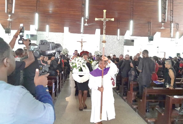 The clergy and wreath  bearers recessing with the pallbearers after the Mass.
