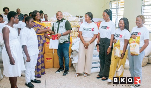 Ben Kofi Quashie (middle), CEO of the BKQ Foundation, presenting the items to Veronica Dery (3rd from left), the Headmistress of the school, while Nonkazimulo Quashie (4th from right), Co-Founder of the foundation, and others look on