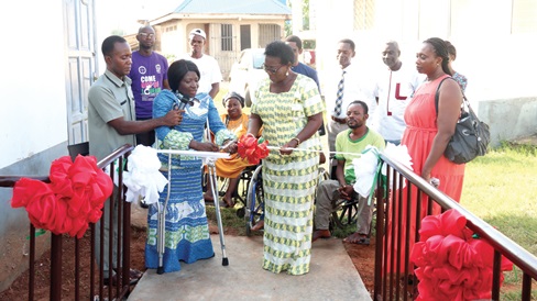 Dr Augustina Naami (2nd from left), Head of Department of Social Work, University of Ghana, Legon, being assisted by Muriel Gilbertson (2nd from right), Board Chairman, Ghana Society for the Socially Disadvantaged, to cut the tape to inaugurate one of the ramps.  Picture: ELVIS NII NOI DOWUONA