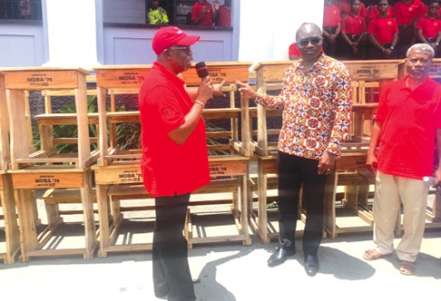 Captain Samuel Hanson Amissah Thompson( left), President of the year group, handing over the mono desks to Rev Ebenezer Kobina Aidoo, Headmaster of the school