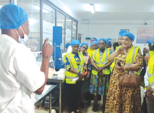 Gizella Tetteh Agbotui (right), MP for Awutu Senya West, and other members of the women caucus of the Minority in Parliament being briefed during the tour of the  production units of the sanitary pads manufacturing factories