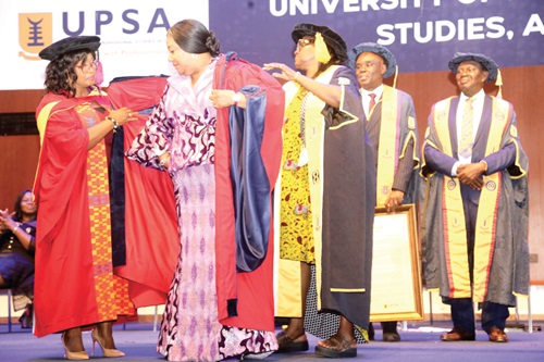 Rebecca Akufo-Addo (2nd from left) being awarded a doctorate degree by officials of the UPSA