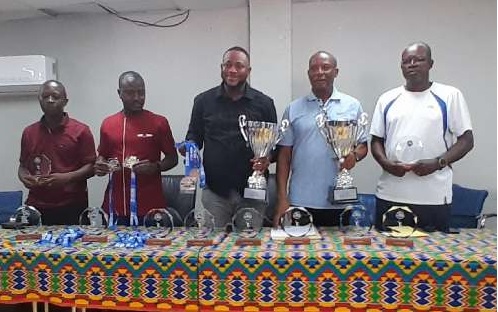 Organisers of the championship displaying trophies and medals at stake