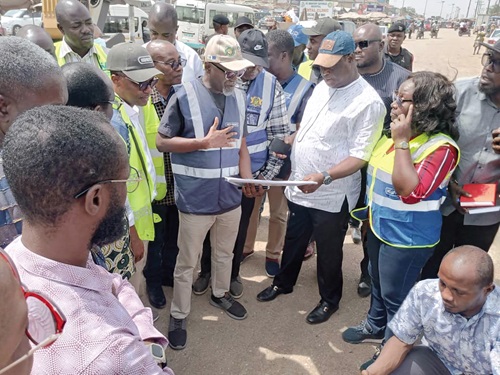Paul Duah (5th from left), Director of Survey and Design, Ghana Highway Authority, explaining the concept of the Kasoa-Winneba dual carriage road project to Kwasi Amoako-Attah (3rd from right), Minister of Roads and Highways