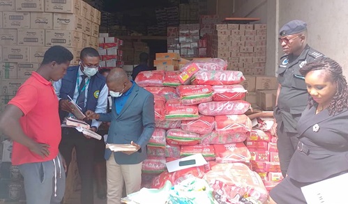 John Yaw Buabeng (3rd from left), Head of Enforcement and Debt Management for the Accra South Area of the GRA, inspecting some of the record books of some of the companies