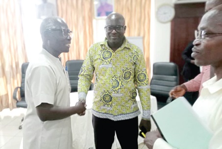 Kwaku Dankwa (right), acting Head of Accra Section of the Research Department of WAEC, exchanging pleasantries with Dr J. A. Sackey, Chief Examiner in Literature-in-English