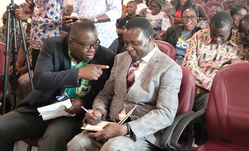 Eric Angel Carbonu (left), President, National Association of Graduate Teachers, conferring with Dr Yaw Osei Adutwum (right), Minister of Education, at the launch. Picture: EDNA SALVO-KOTEY
