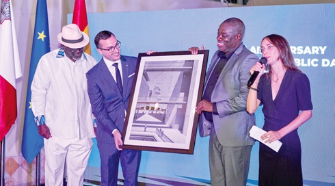 Jean Claude Galea Mallia (2nd from left), Maltese High Commissioner to Ghana, presenting one of the artworks at the exhibition to Dr Ibrahim Mohammed Awal (2nd from right), Minister of Tourism, Arts and Culture
