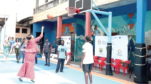 Elizabeth Sackey (left), Chief Executive of Accra Metropolitan Assembly, aiming a basketball at a net as part of activities to commemorate the International Migrants Day in Accra. Picture: ELVIS NII NOI DOWUONA
