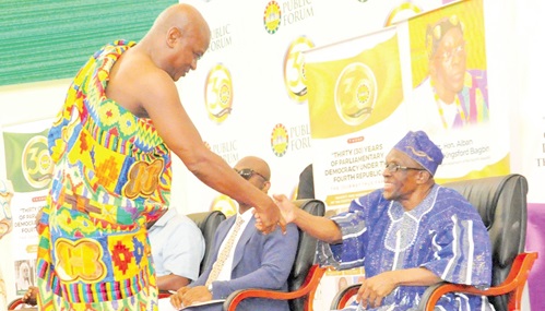 Togbe Afede XIV (left) and Alban Sumana Kingsford Bagbin, Speaker of Parliament, exchanging pleasantries at the forum
