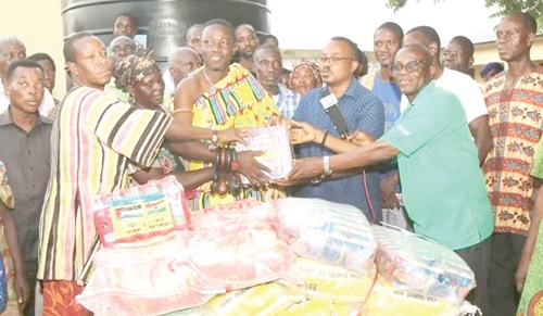 Samuel Kotei (2nd from right), GTV Cares Coordinator,  and John Gadawusu (right), Volta Regional Director of GBC, presenting the items to Togbe Borbordzi, Manklalo of Battor