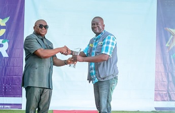  Alexander Akwasi Acquah (left), MP for Akyem Oda,  presenting an award to Akwasi Azor