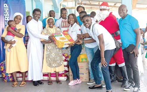 Sandra Amarquaye (arrowed), Corporate Communications Manager of Karpowership Ghana, with the support of members of her team, presenting the food items to the Managers of Egyam Home led by Rev. Sister Mary Gladys Boakye (3rd from right)