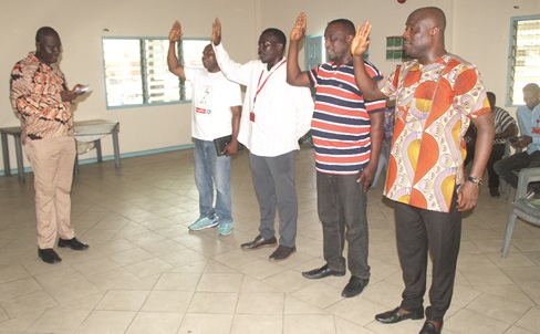 Ernest Otu Addo (left), Regional ICU Officer, administering the oath of office to the new executive members of the Graphic Local Union. They are from right: Romeo Torkornoo, Chairman; Sampson Dangmah, Vice-Chairman; Nana Yaw Osam-Dade, First Trustee, and Samuel Ansah, Executive Member. Picture: ESTHER ADJORKOR ADJEI