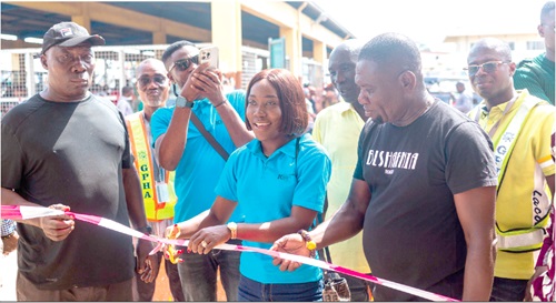 Sandra Amarquaye (middle), Corporate Communications Manager of Karpowership Ghana, cutting the tape to inaugurate the shed.  With her are some officials of Karpowership and other dignitaries