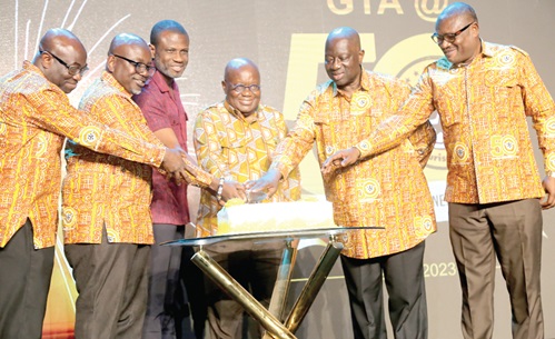 President Akufo-Addo (middle) with  Mark Okraku-Mantey (3rd from left), a Deputy Minister of Tourism; Seth Adjei Baah (2nd from right), Chairperson, Ghana Tourism Authority; Akwasi Agyemang (2nd from left), Chief Executive Officer, Ghana Tourism Authority; Ekow Sampson (right), a Deputy CEO in charge of Operations, and Ben Anane Nsiah (left), Deputy CEO in charge of General Services, GTA, to cut the 50th anniversary cake Picture: SAMUEL TEI ADANO