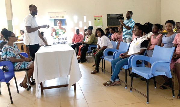 • Dr Prince Yeboah Agyeman (standing), Medical Officer in-charge of the Nsoatre Health Centre, educating women about cervical cancer